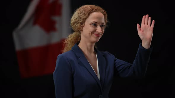 Canadian Politician Woman Smiling Waving Looking Away at Black Background with National Flag