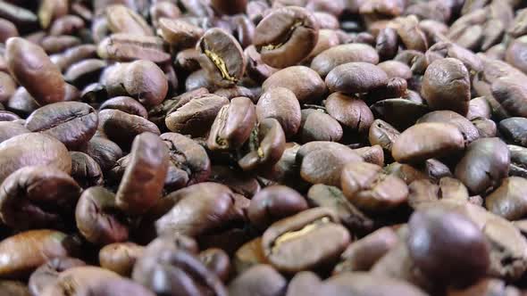 Close-up of Roasted Coffee Beans Are Falling and Spinning in Slow Motion