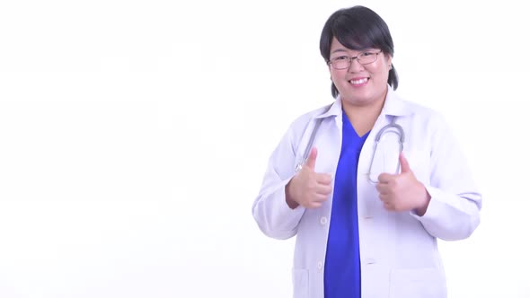 Happy Overweight Asian Woman Doctor Touching Something and Giving Thumbs Up