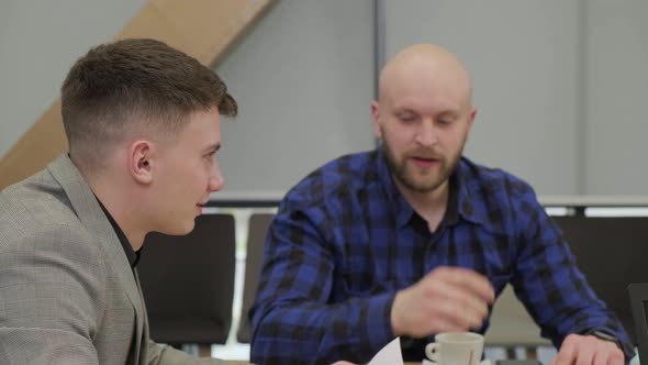 Close Up of a Businessman That is Talking with His Colleague During the Meeting