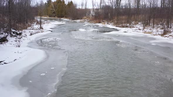 icy winter river stream low flight aerial