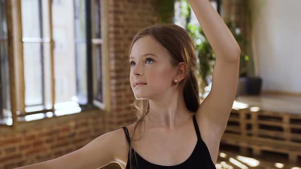 Graceful Young Ballerina in Black Body and Skirt Practicing Dance Moves