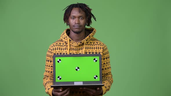 Young Handsome African Man Showing Laptop