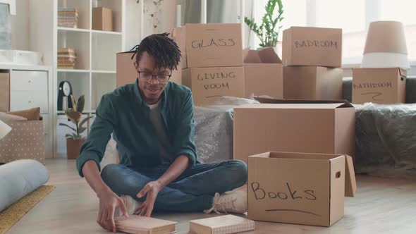 African Man Packing Stuff for Moving