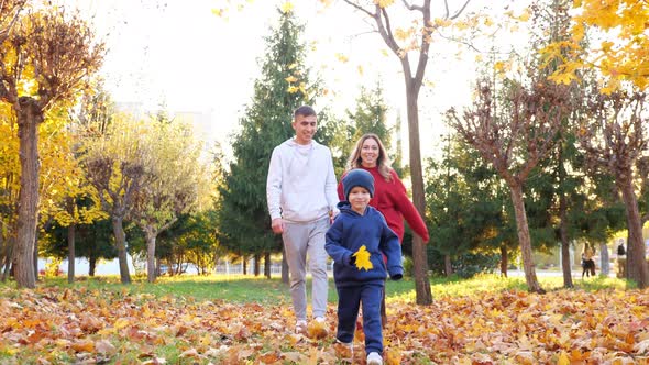 Little Son Runs Ahead Mom and Dad Walking Along Autumn Park