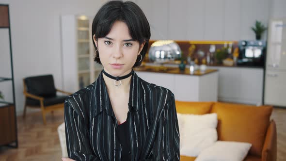 Happy Attractive Young Adult Woman Standing in the Kitchen Looking at Camera in Modern Cozy Home