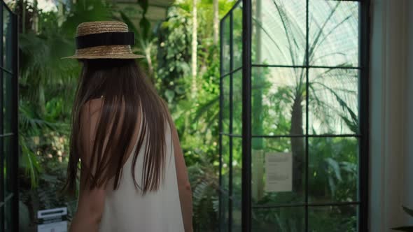 Young Woman is Viewing a Greenhouse