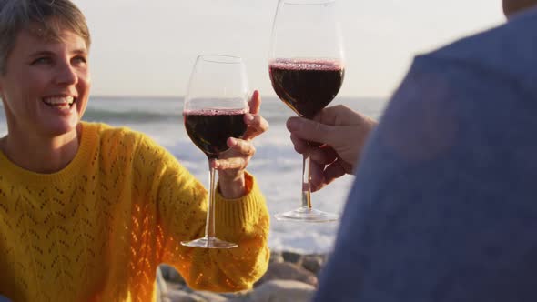 Couple drinking wine by the sea