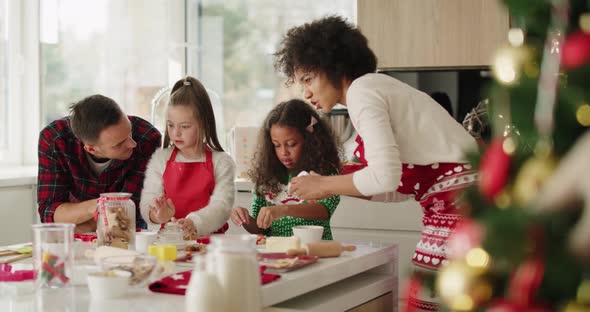 Family making yummy cookies for Christmas