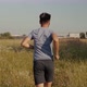 Running Man On Green Grass Field.Slow Motion Running Man Exercising On Trail.Man Running On Park - VideoHive Item for Sale