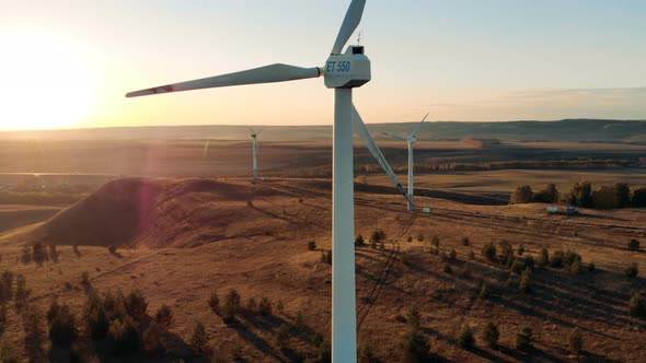 Sunlit Landscape with Several Windmills Revolving. Wind Energy, Wind Electricity Generation Concept