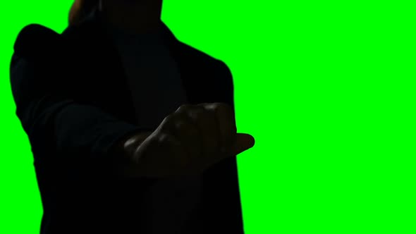 Woman making hand gesture against green screen background