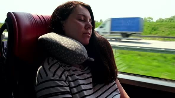 Woman Travel on Bus Sleeping with a Pillow