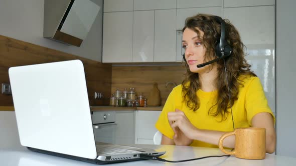 Young Woman is Having Online Meeting Using Her Laptop Businesswoman with Digital Tablet Sitting on