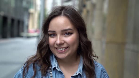 Cheerful Brunette Woman Is Strolling Alone at City Street at Summer, Smiling, Portrait Shot