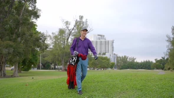 Golfer Walking To The Next Hole On A Golf Course