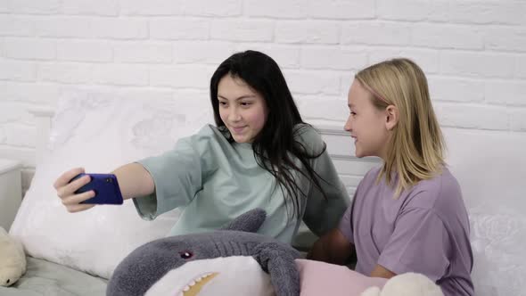 Two Young Multinational Girls Spending Time Together Pajama Party