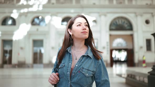 Handsome brunette woman tourist walking with backpack