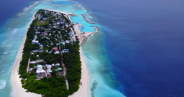 Natural flying abstract view of a sandy white paradise beach and blue ocean background in 4K