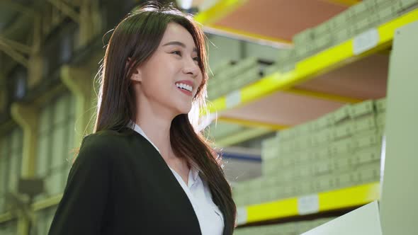 Asian beautiful business woman work in industrial manufacturing plant.