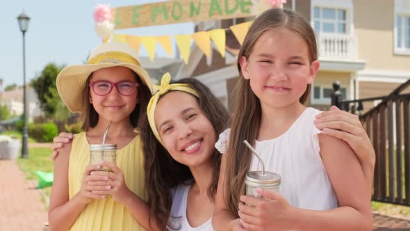 Portrait Of Mom With Daughters On Summer Day