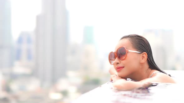 Young asian woman enjoy around outdoor swimming pool for leisure