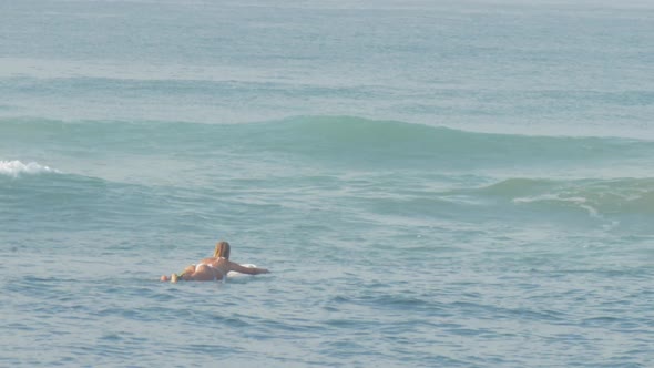 Slim Lady Lies on Board and Rows Across Endless Blue Ocean alt