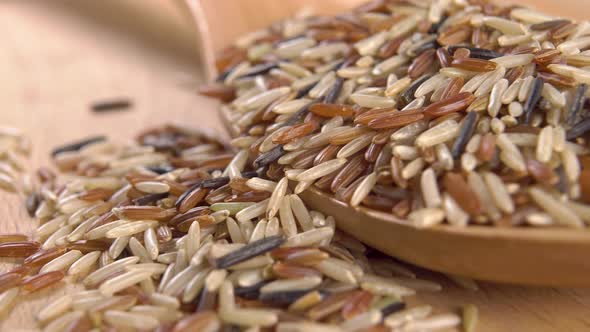 Basmati rice mix in a wooden spoon on a board. Macro