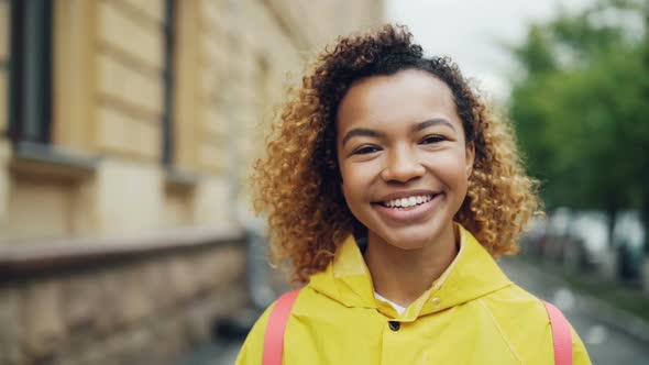 Close-up Slow Motion Portrait of Cute Mixed Race Young Lady Smiling and Looking at Camera with