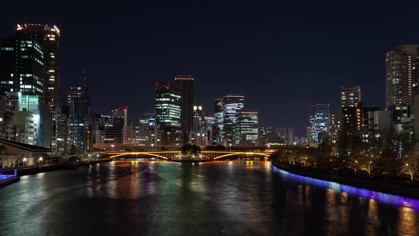 Night Osaka River Bridge at Skyscrapers Timelapse