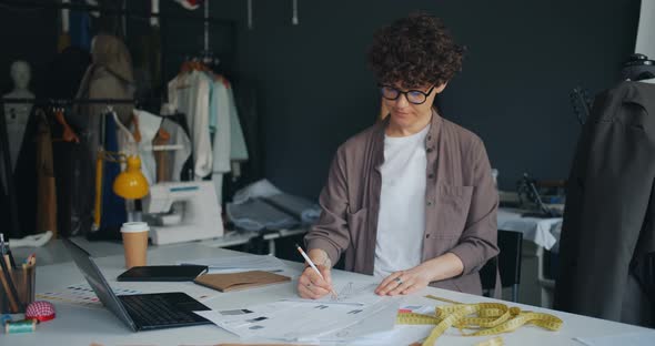 Creative Lady Designer Sketching Drawing Clothes Working in Modern Studio