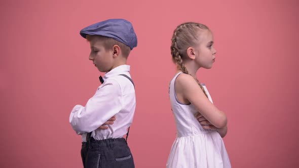 Sad Kids Couple Standing Back in Silence After Quarrel, Isolated Pink Background