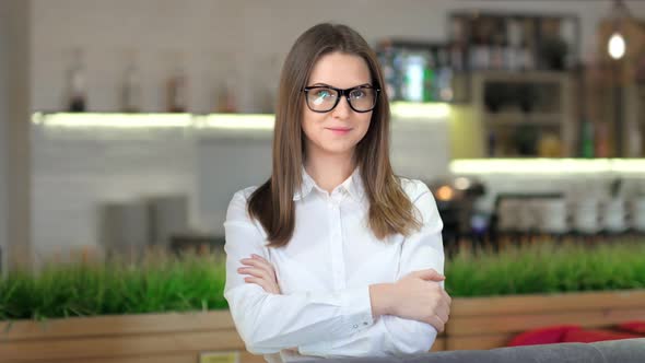 Portrait of Smiling European Businesswoman Wearing Glasses and White Classic Shirt