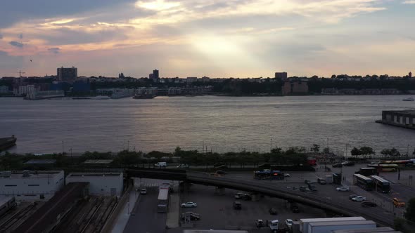 Slow rise up to a colorful sunset, as a bird flies to the left  in Hudson Yards in New York