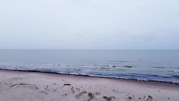 Aerial view of Baltic sea coastline at Bernati beach in Latvia, flying backwards through tight coast