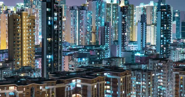 Residential Buildings' Windows Twinkle at Night. Crowded City With Lights Turning On And Off
