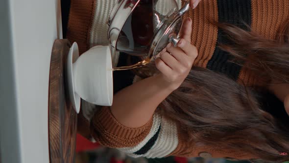 Vertical Video Close Up of Woman with Kettle Pouring Tea in Cup at Home