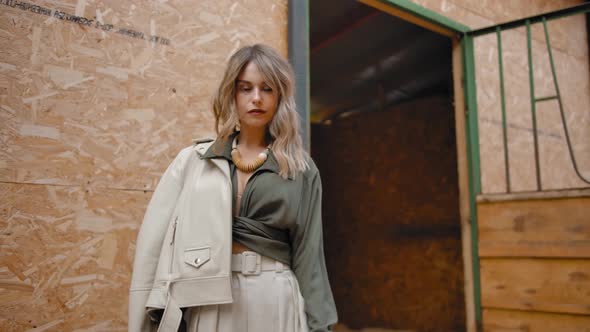 Stylish Lady Near Open Stall on Farm