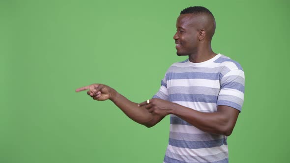 Young Happy African Man Showing Something