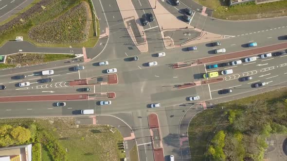 Aerial birds eye view drone view of a busy intersection junction with lots of cars and traffic durin