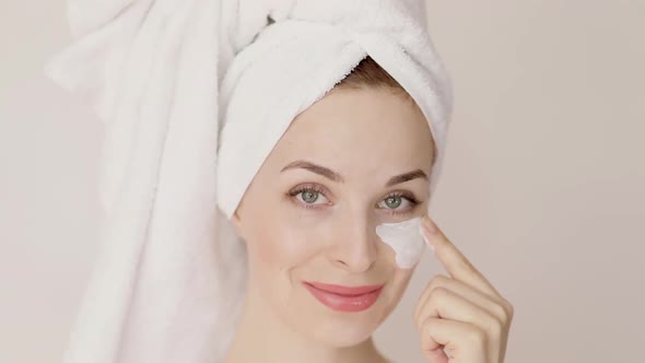 Portrait of Charming Caucasian Woman in White Towel Applying White Clay Beauty Mask on Her Face with