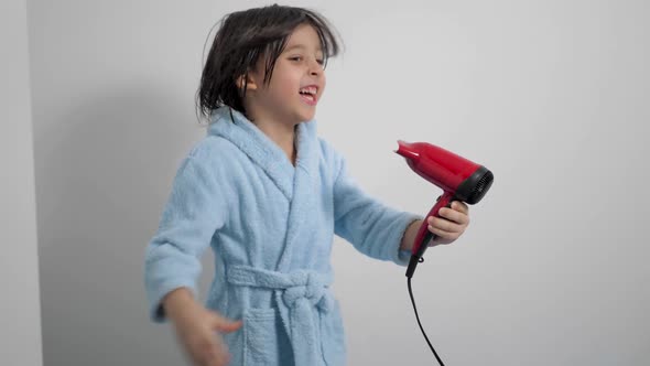 Portrait of a Five Year Old Boy After a Bath in a Blue Bathrobe and Dries