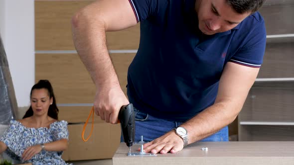 Zoom in Man Assembling Furniture in New House