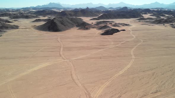 Day top view of the Sahara desert, desert mountains. Sands.