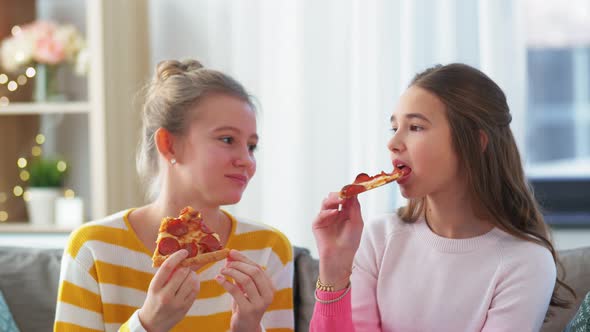 Happy Teenage Girls Eating Takeaway Pizza at Home