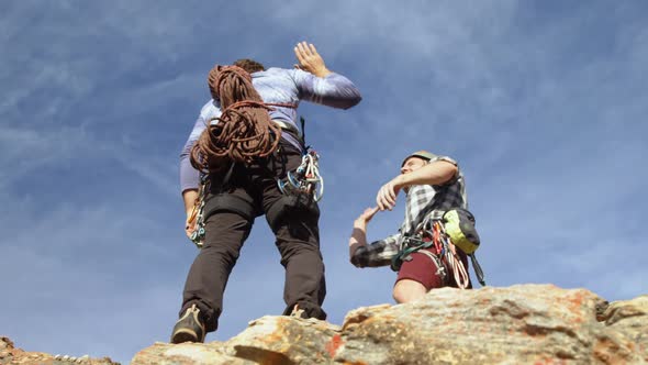 Climbers reaching successful on top of mountain