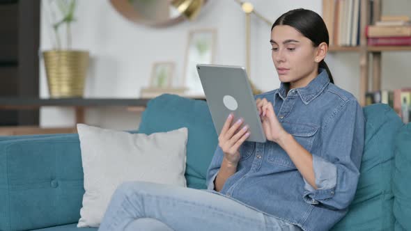 Latin Woman Using Tablet on Sofa 