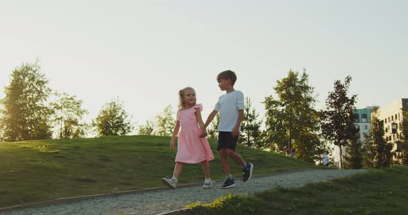 A Boy and a Girl are Walking in the Park