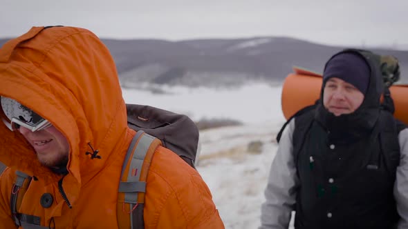 Front Shot of Two Travelers Hiking in Winter.