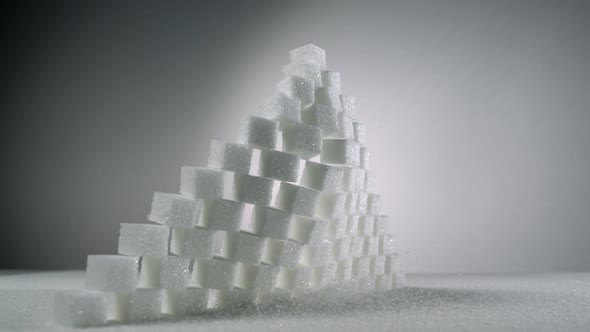 Slow-motion stack of sugar cubes falls